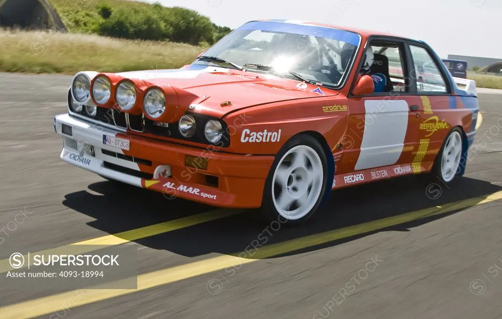 1987 BMW E30 / M3 Rally Car driving fast down an empty road