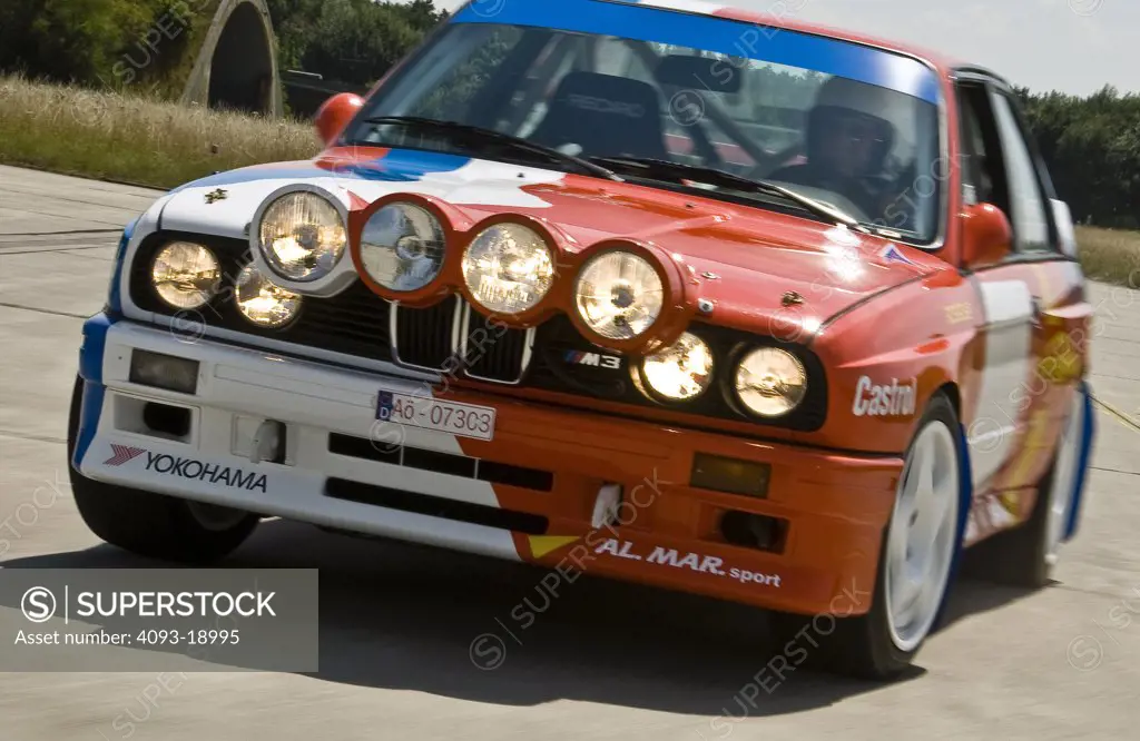 1987 BMW E30 / M3 Rally Car driving fast down an empty road