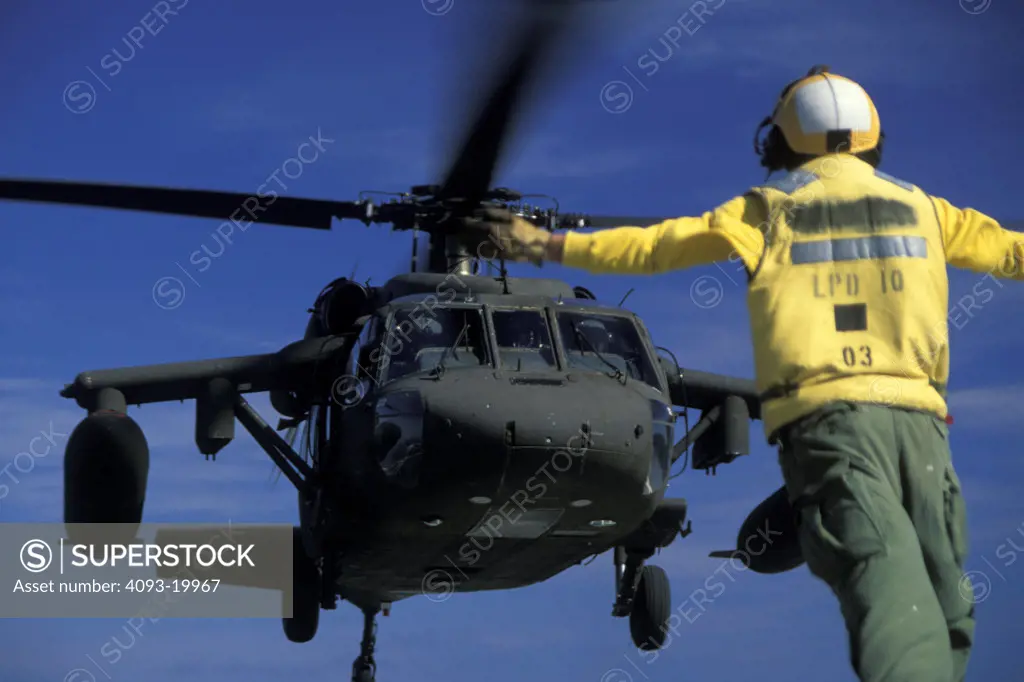 Sikorsky Military Helicopters Aviat UH-60A Black Hawk approach landing takeoff U.S. Army signalman