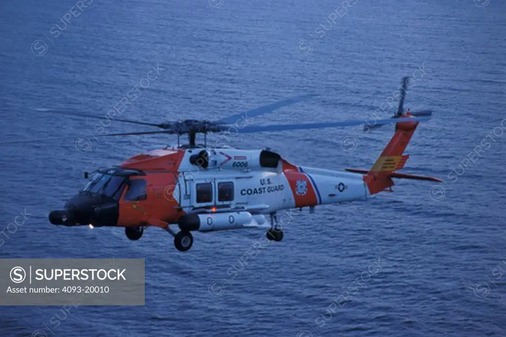 US coast guard heli helicopter hovering ocean water looking lights