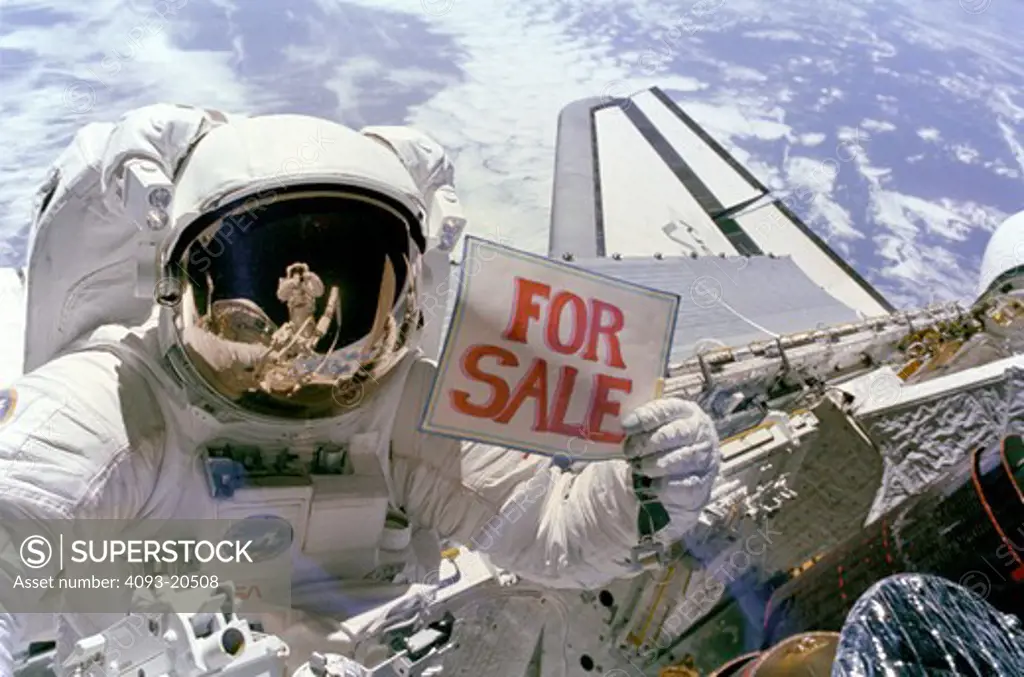 Astronaut Dale A. Gardner  having just completed the major portion of his second extravehicular activity (EVA) period in three days  holds up a For Sale sign refering to the two satellites  Palapa B-2 and Westar 6 that they retrieved from orbit after their Payload Assist Modules (PAM) failed to fire.