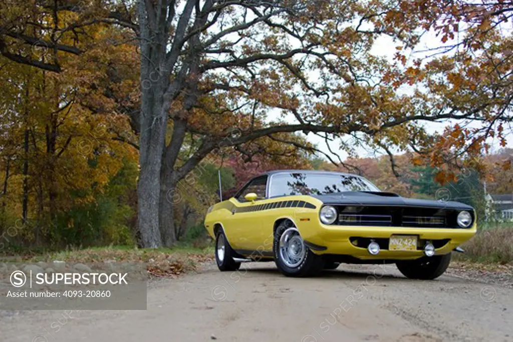 1970 plymouth AAR barracuda on a country road.
