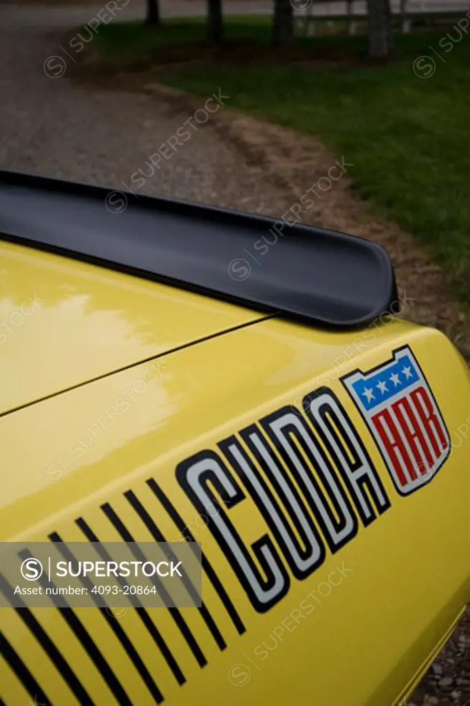 1970 plymouth AAR barracuda 'cuda on a country road. Close-up of logo.