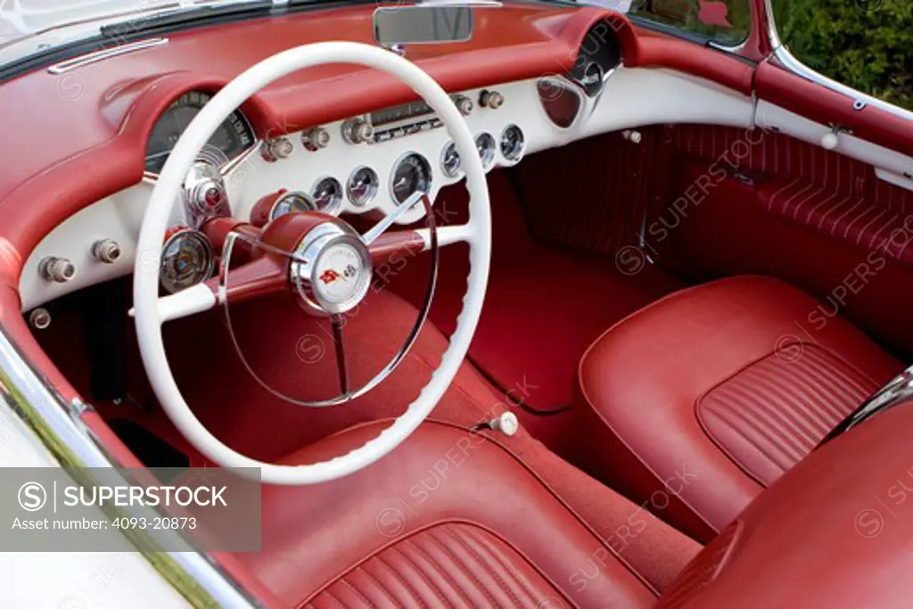 1953 corvette in Polo White with a red interior and a black canvas top.