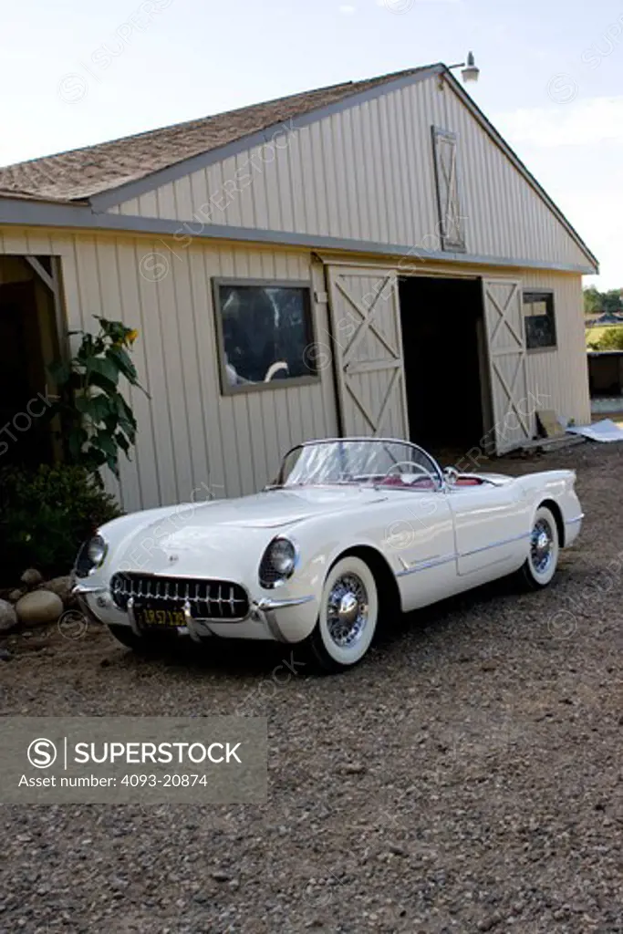 1953 corvette in Polo White with a red interior and a black canvas top.