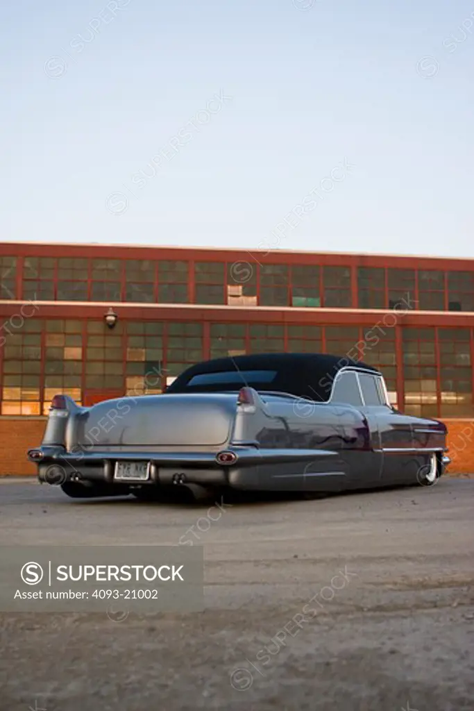 1955 Customized Cadillac Firemaker parked in front of warehouse, rear view