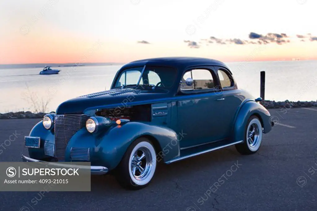 1939 Customized Chevrolet parked by lake at dusk