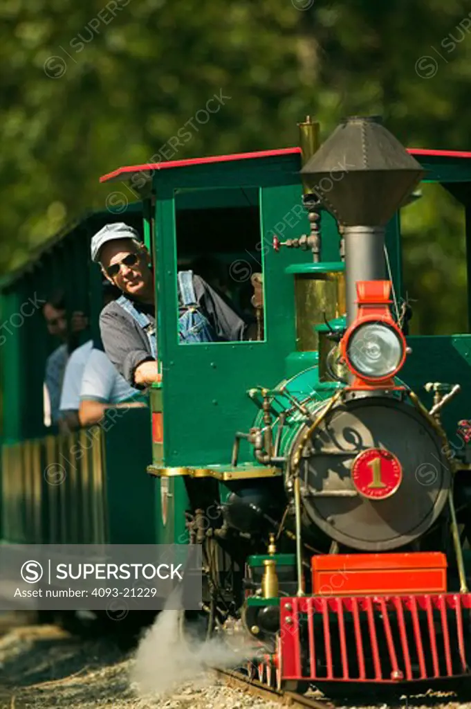 The train approaches with conductor