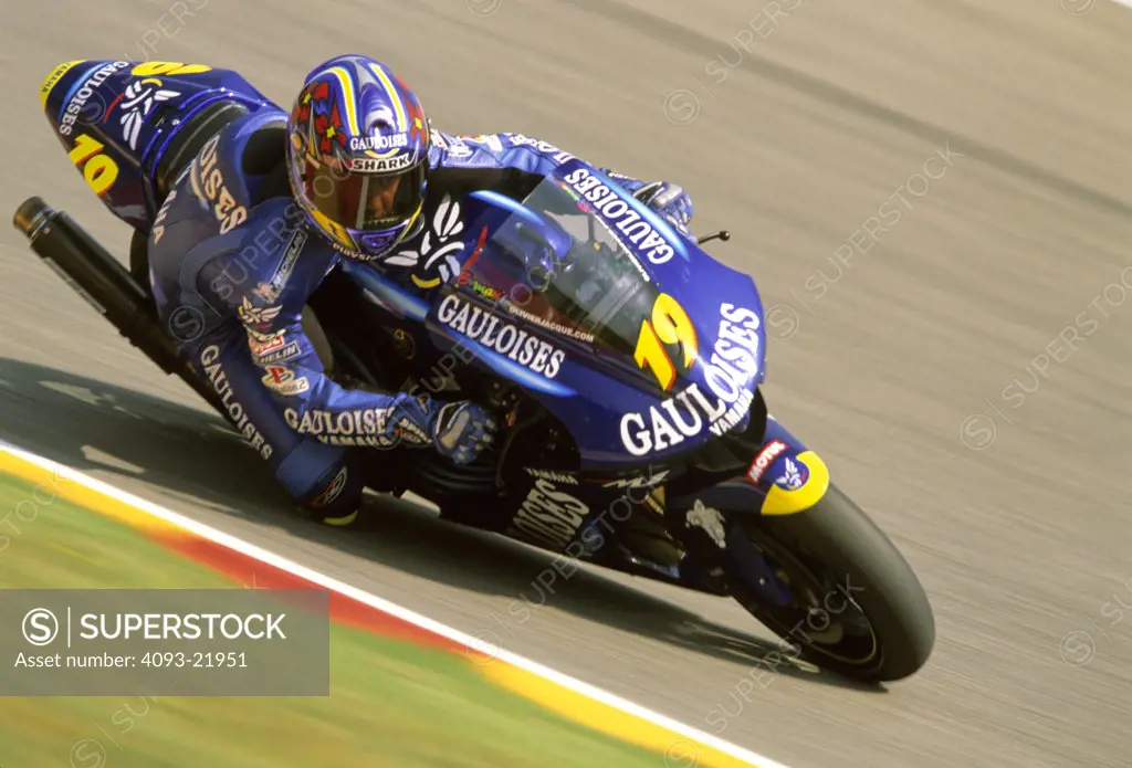 Yamaha MotoGP Olivier Jacque blue cornering lean curb red yellow