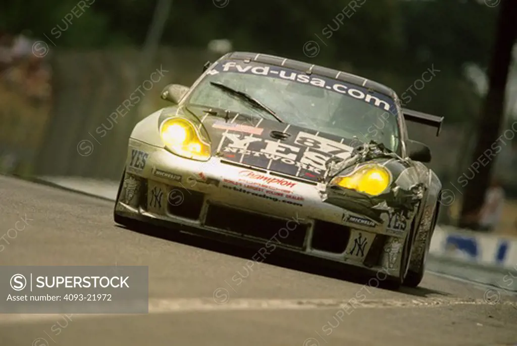 Porsche 911 silver black with headlights on at Le Mans, France.