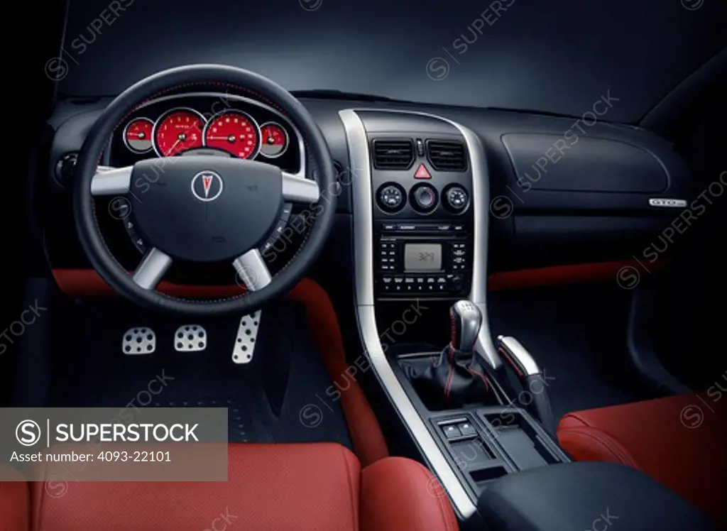 interior Pontiac GTO 2005 red leather seats dashboard black silver trim steering wheel gauges gear shift