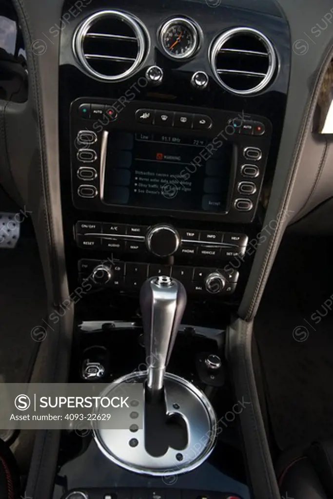 Interior detail view of a 2009 Bentley Continental GT showing the shifter, radio and GPS navigation display.