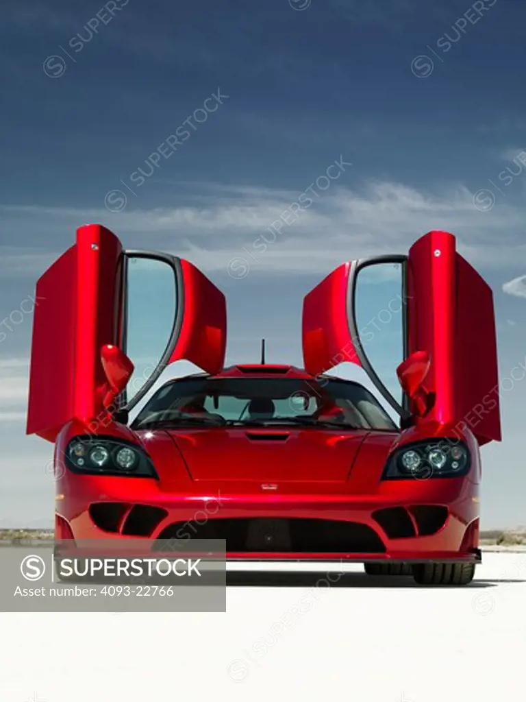 Straight, nose view of a red 2009 Saleen S7 with the doors raised on El Mirage dry lake.  The Saleen S7 is a limited production, hand built high-performance automobile. It is the first car produced by Saleen not based on an existing design.