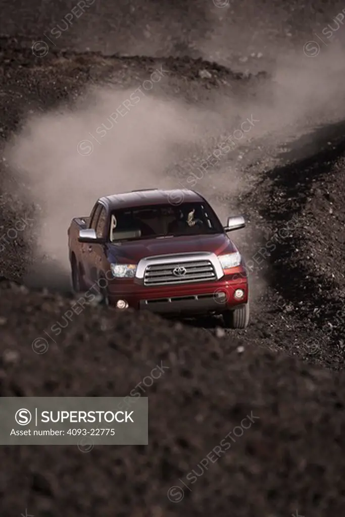 Front action view of a 2009 Toyota Tundra on a dirt road.