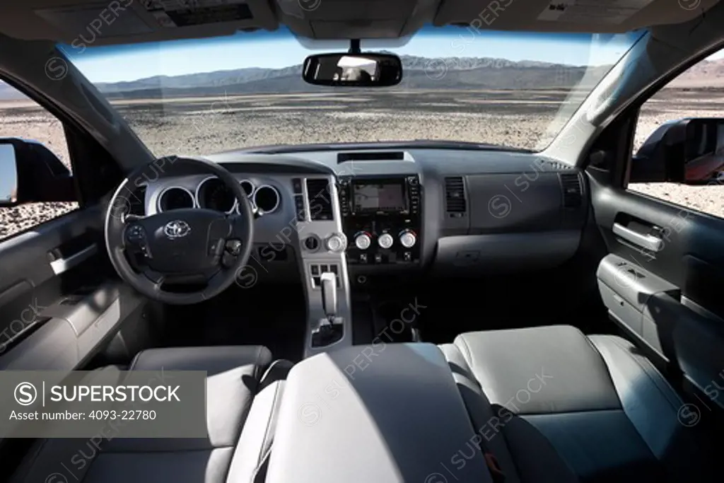 Interior view of a 2009 Toyota Tundra showing the seats, steering wheel, instrument panel, shifter, GPS navigation and ventilation system.