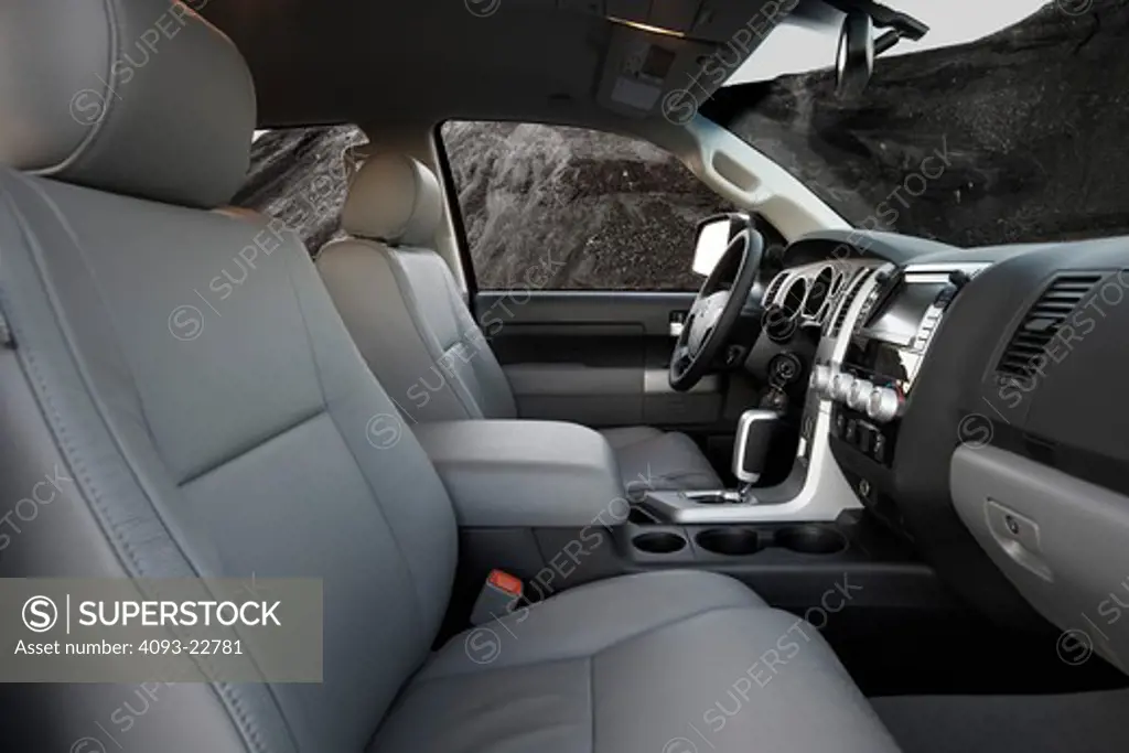 Interior view of a 2009 Toyota Tundra showing the seats, steering wheel, instrument panel, shifter, GPS navigation and ventilation system.