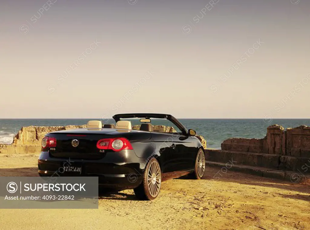 2009 Volkswagen EOS near the cliffside of a road in the evening.