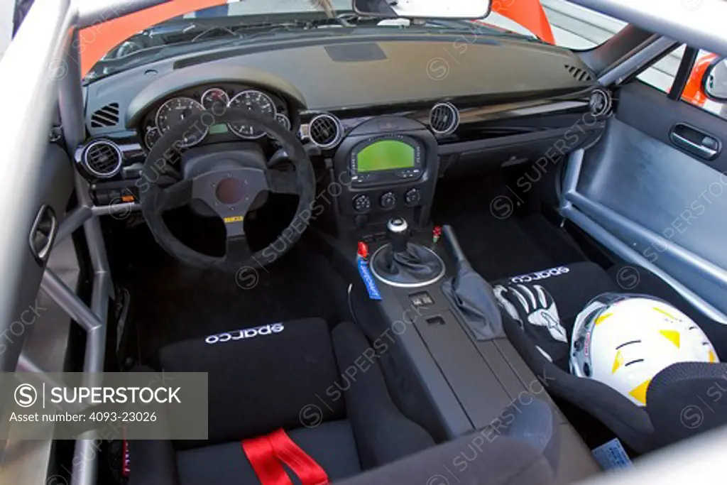 interior Mazda Miata MX-5 2006 steering wheel seats dashboard black helmet gloves gauges roll cage