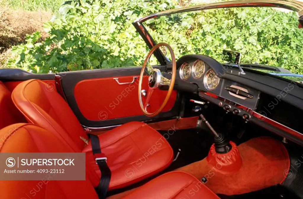 interior Alfa Romeo Giulietta 1959 1950s red leather seats steering wheel wood dashboard black gear shift