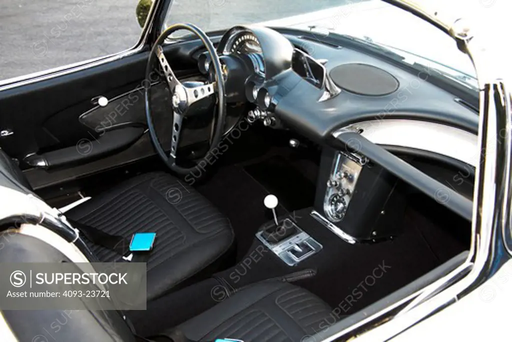 Interior view of a 1958 Chevrolet Corvette. Taking its name from the corvette, a small, maneuverable fighting frigate, the first Corvettes were virtually handbuilt. The outer body was made out of a revolutionary (at the time) new composite material called fiberglass. Underneath that radical new body were standard Chevrolet components, including the Blue Flame inline six-cylinder engine, two-speed Powerglide automatic transmission, and drum brakes from Chevrolet's regular car line. ( vehicle - PR