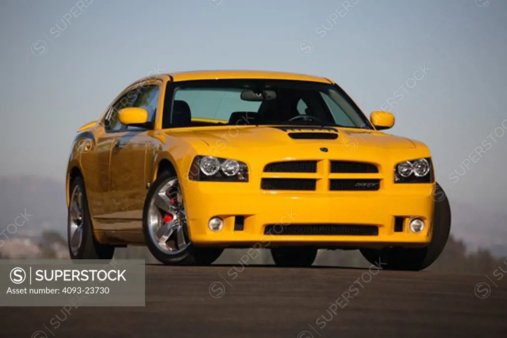 Front 3/4 static view of a bright yellow 2007 Dodge Charger Super Bee. The Super Bee version of the Charger debuted at the 2006 New York International Auto Show for the 2007 model year. It shares the SRT-8's 425 hp (317 kW) 6.1 L Hemi engine but comes in special Detonator Yellow paint with black decals. It is a limited edition with only 1000 being produced for the entire world . ( PR )