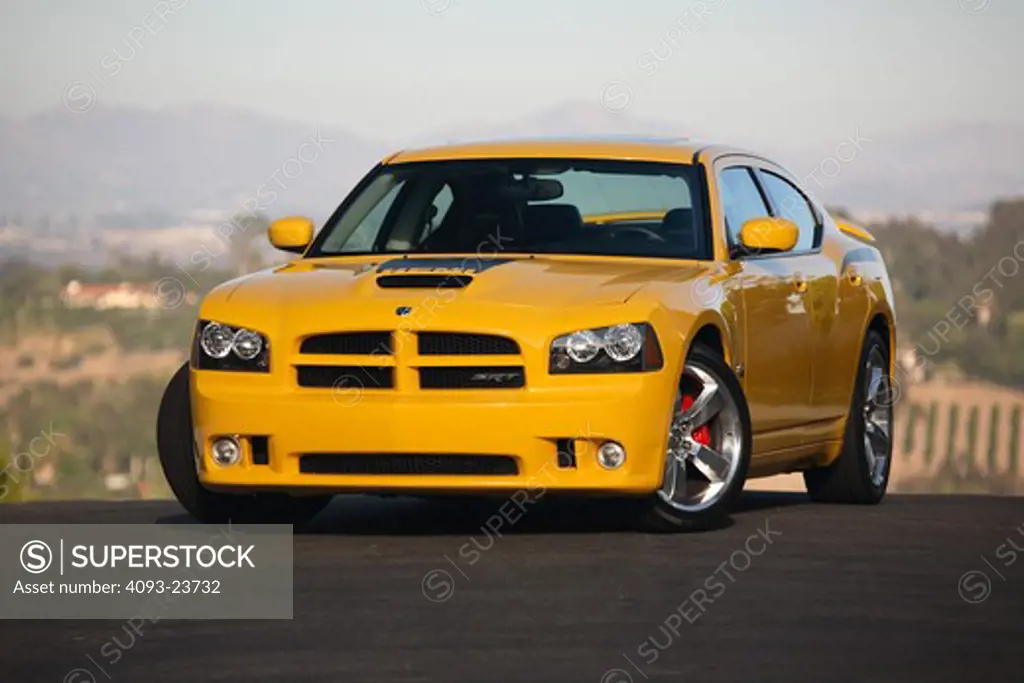 Front 3/4 static view of a bright yellow 2007 Dodge Charger Super Bee. The Super Bee version of the Charger debuted at the 2006 New York International Auto Show for the 2007 model year. It shares the SRT-8's 425 hp (317 kW) 6.1 L Hemi engine but comes in special Detonator Yellow paint with black decals. It is a limited edition with only 1000 being produced for the entire world . ( PR )