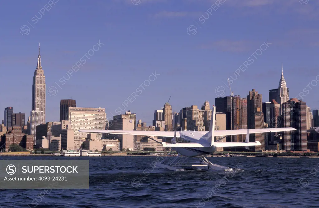 Prop General Aviation Fixed Wing Cessna Aviat Airplanes charter Caravan seaplane floats floatplane amphibian buildings New York City skyline amphibious city