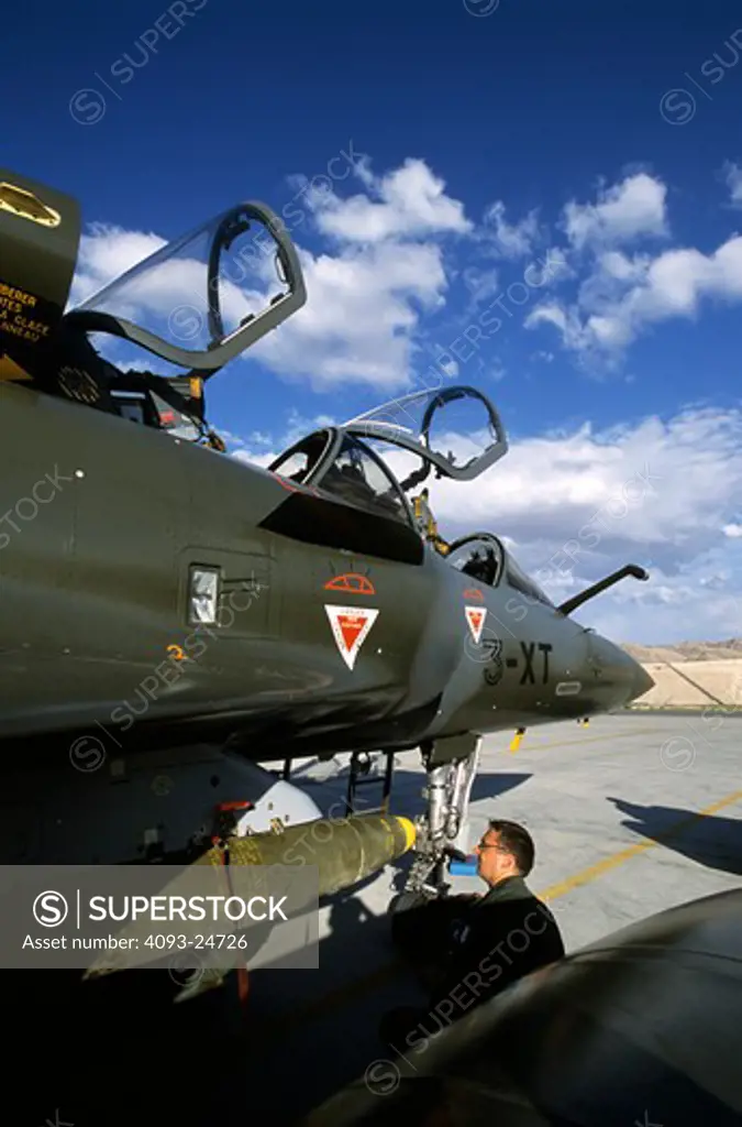 French Air Force Dassualt MFG  Mirage 2000 fighter-bomber  ground crewman loading 500 pound bombs/ordnance. Taking part in Red Flag exercises at Nellis Air Force Base  Las Vegas  NV.