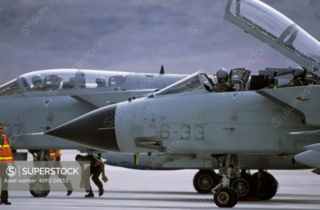 Italian F-3 Tornados wait at the EOR or last chance as crews remove safeties from guns and ordnance immediately prior to takeoff for a Red Flag mission at Nellis AFB, NV.