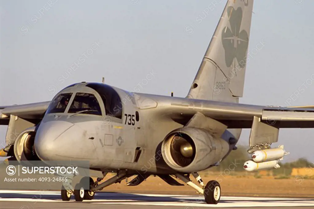 US Navy Lockheed S-3 Viking anti submarine / sea control aircraft prepares for a training mission at Naval Air Field El Centro in the Imperial valley. The aircraft is carrying live CBU's (cluster bomb) on the left pylon (R in photo) and live 500lb slicks on the opposite side.