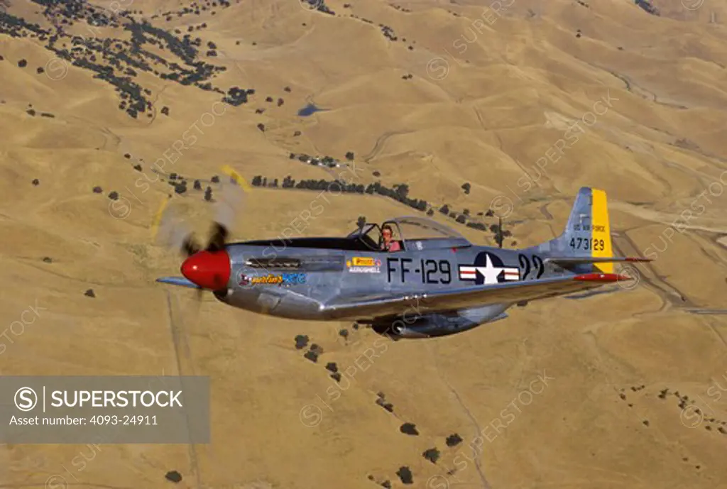 North American P-51D Mustang  Merlin's Magic owned by Stu Eberhardt holds a close formation over the California foothills near Livermore  CA.