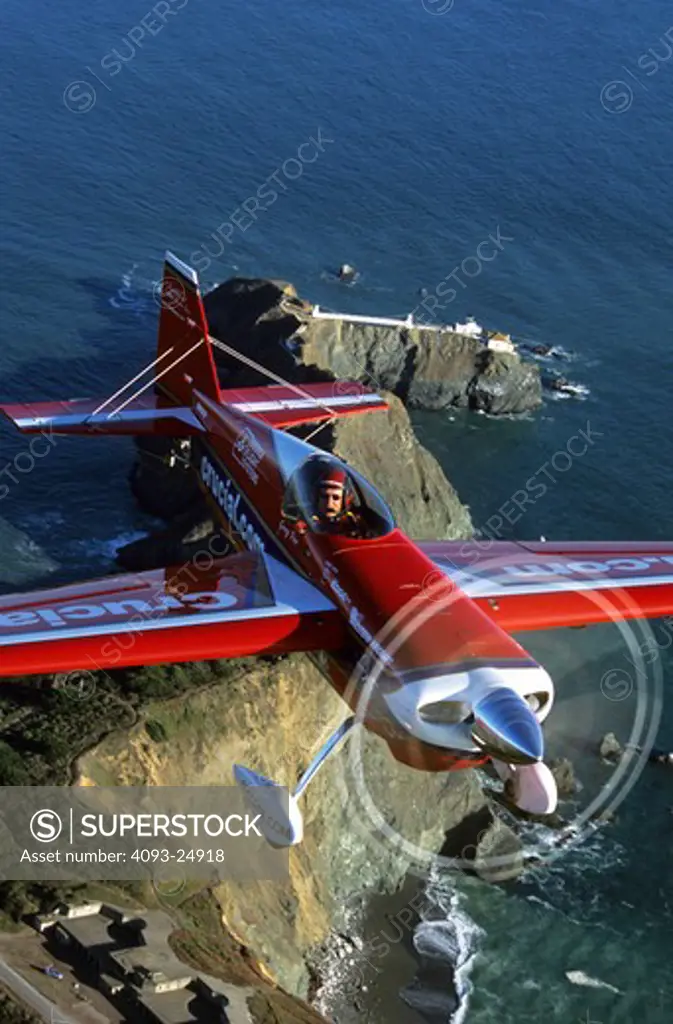 Air show veteran Greg Poe in his Edge 540 over the headlands and light house northeast of San Francisco, CA.