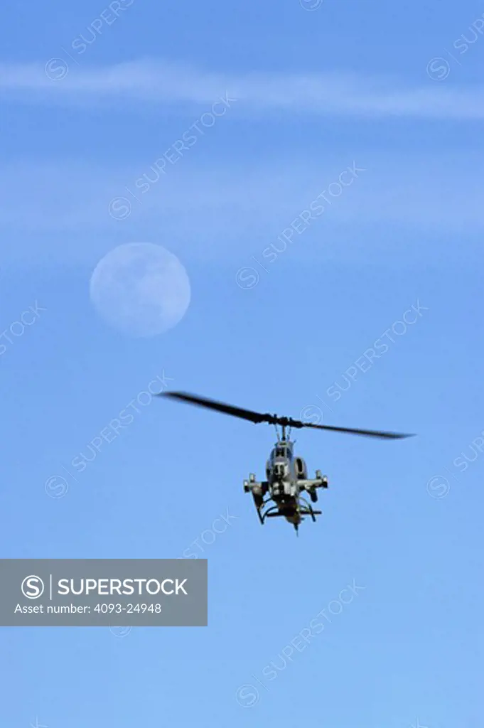 US Marine Corps AH-1 Cobra helicopter with full moon