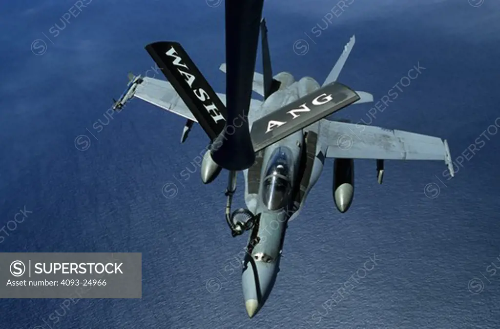 US Navy Boeing F/A-18C above the Pacific Ocean  attached to aerial (air to air) refueling tanker boom  Washington Air National Guard