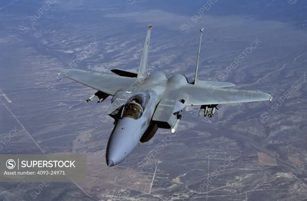 USAF F-15C Eagle from Langley AFB photographed from a USAF tanker above desert ground terrain