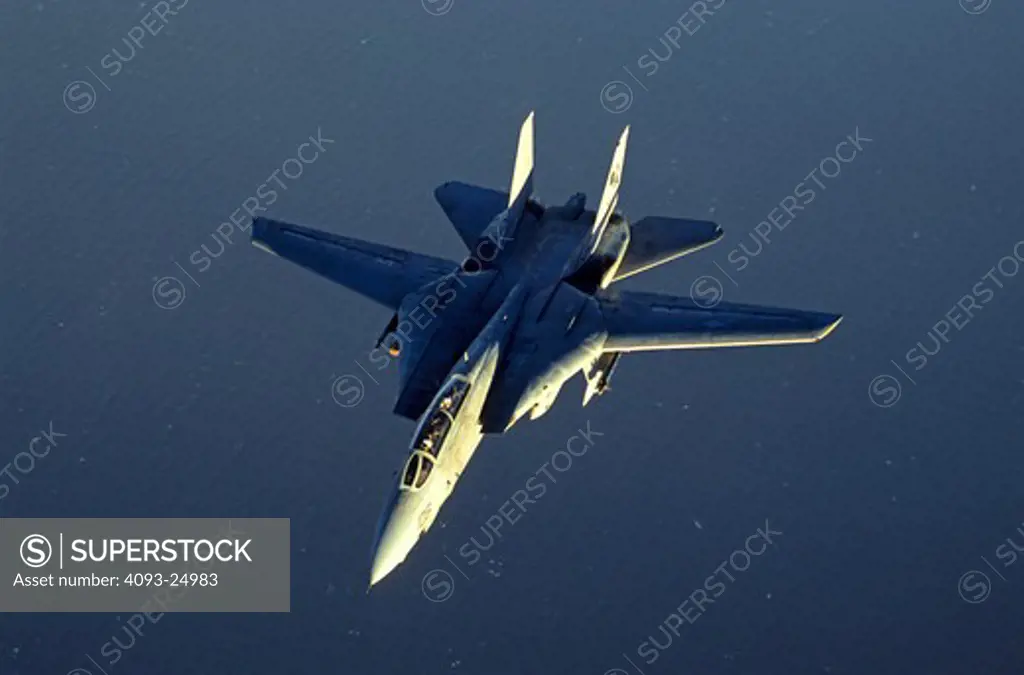 US Navy VF-31 Tomcatters Grumman F-14D Tomcat above the Pacific Ocean near Hawaii at sunset