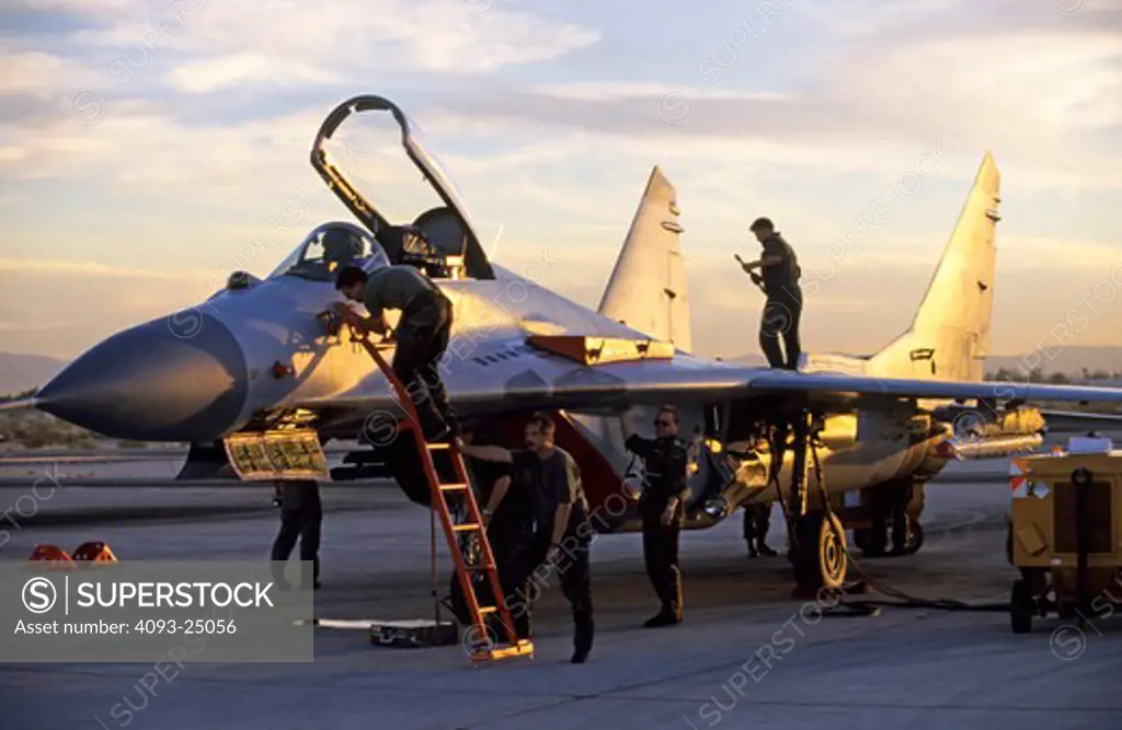 German Air Force Mig-29 Fulcrum with ground crew members prepare the aircraft for a night mission  at sunset  Red Flag exercise  Nellis AFB  NV