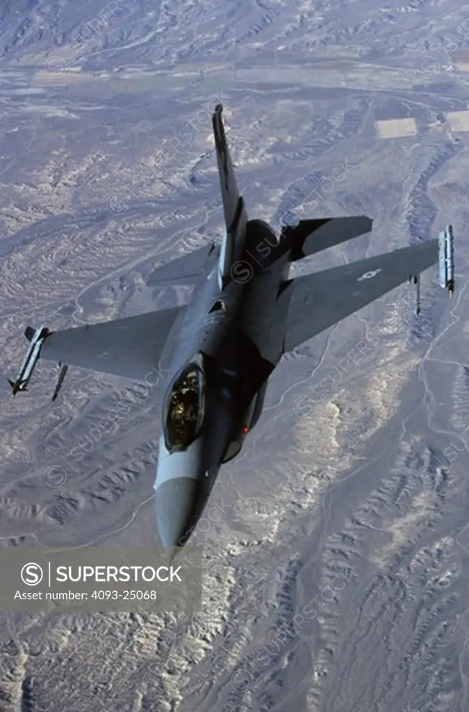 A-A image USAF Lockheed F-16C Fighting Falcon (Viper) over a desert background.