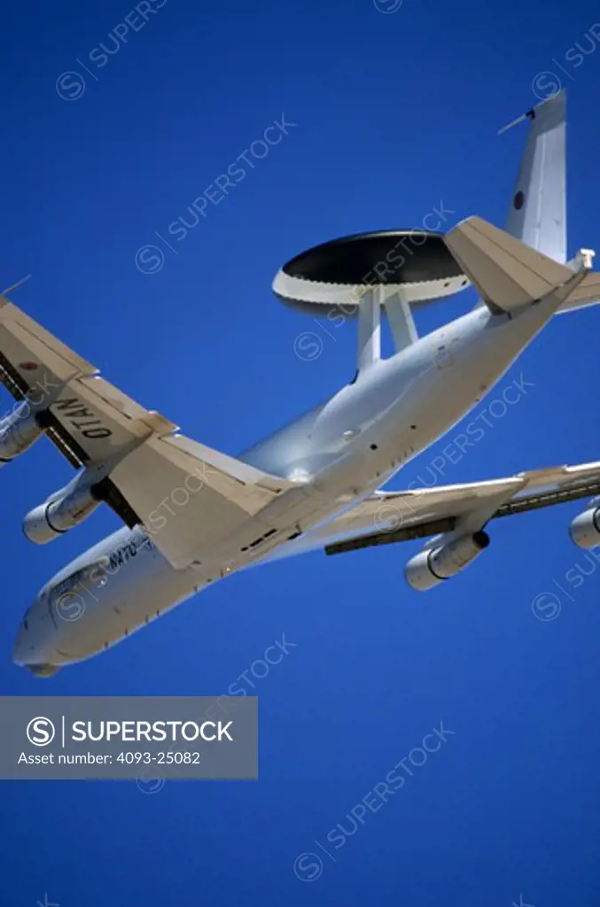 A NATO Boeing E-3 Sentry AWACS aircraft takeoff. Vertical image cropped tightly.
