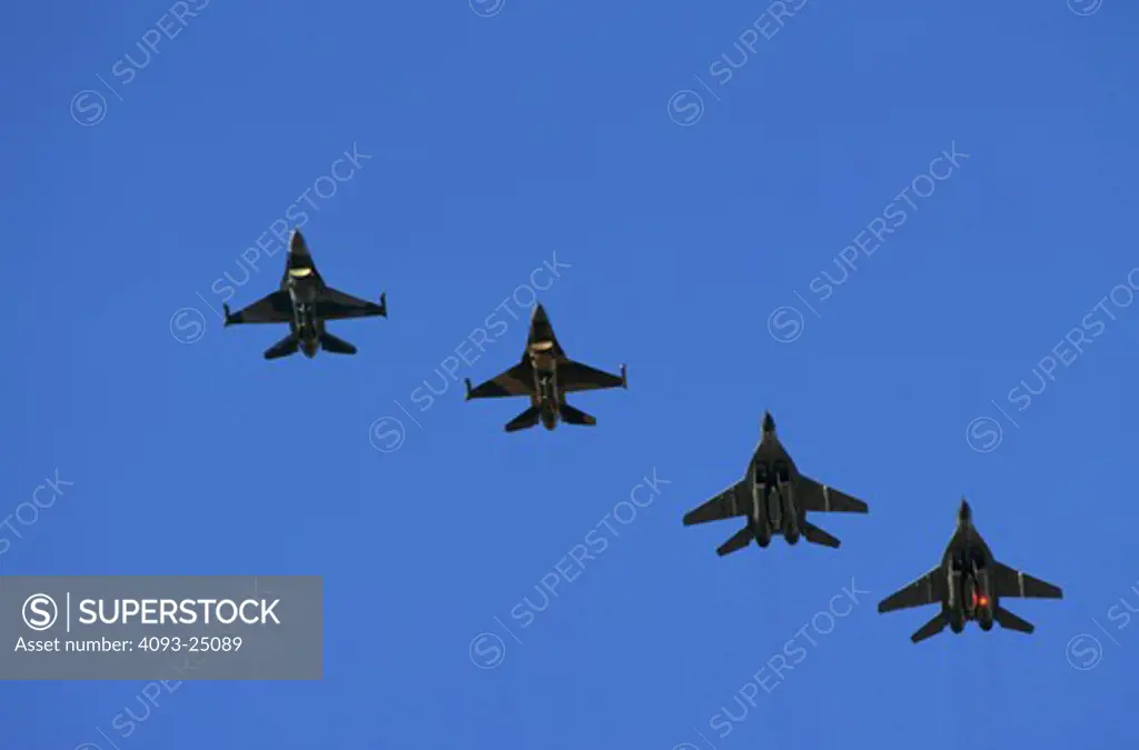 A mixed formation: a two ship formation of German Air Force (Luftwaffe) Mig-29 Fulcrum with a two ship formation of USAF F-16 Fighting Falcon Aggressors of the 64th Aggressor Squadron escort  returns from Red Flag exercise mission with ordnance  Nellis AFB  NV.