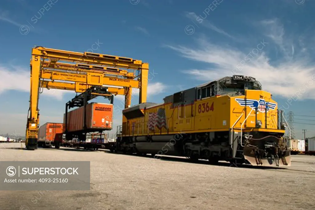 Train offload heavy machinery blue sky locomotive
