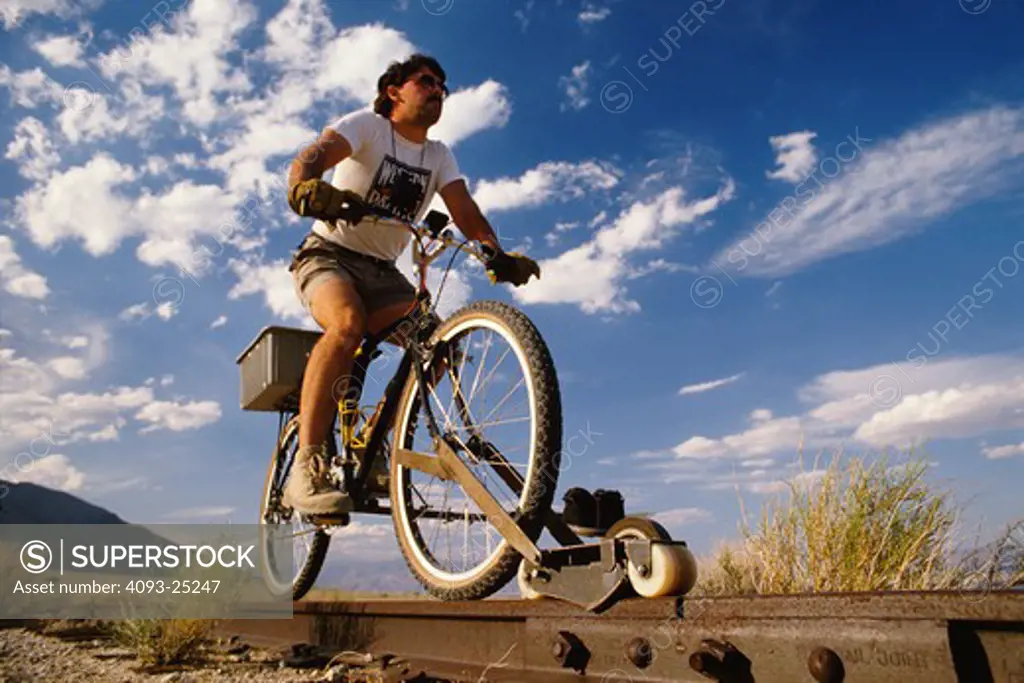 Railcycle rider Steve Crise rides his home made railcycle on the abandoned tracks of the Southern Pacific railroad near Inyokern,Calif 1988.