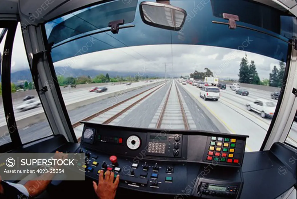 View from a MTA Gold Line Car as it speeds in-between the lanes of Interstate Highway 210 in Pasadena  California toward its terminal station in downtown Los Angeles. The route of this line was rebuilt upon the old Atchison  Topeka and Santa Fe railroads right of way that ran from Los Angeles to San Bernardino. 4-30-03.