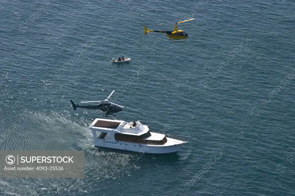 Eurocopter AS350 Ecureuil A-Star Helicopter flying over the Pacific Ocean near Malibu, CA during a Fast Rope type military operation onto a yacht.