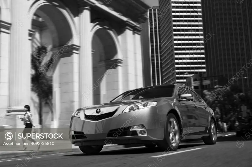 2009 Acura TL driving through city streets, front 3/4