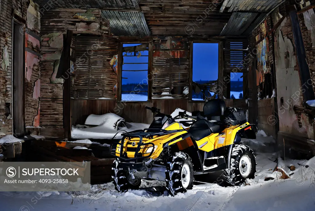 2007 Can Am Outlander 800 Max shot in an old barn house in the snow. ATV All Terrain Vehicle