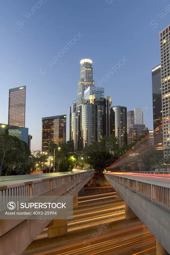 View of downtown Los Angeles L.A. with traffic light streaks above and below the bridge.