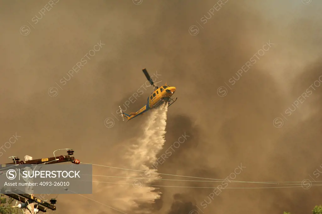 Ventura County Fire Support Helicopter 1969 Bell Helicopter Rotorcraft going toward fire smoke covered sky smokey yellow sky ashes from fire