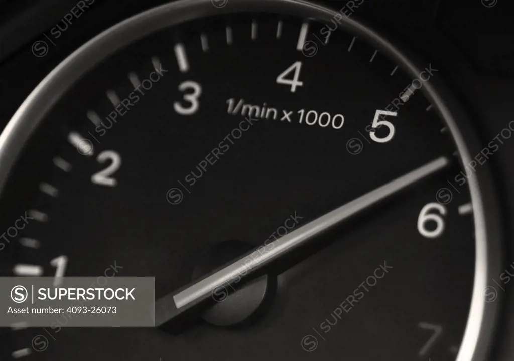 2002 Audi A4 1.8T detail view close up of instrument tachometer in studio shoot with solid background backdrop