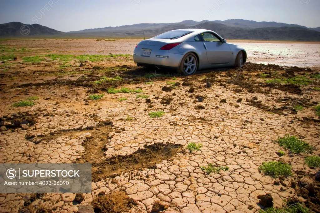 2004 Nissan 350Z off roading in the mud dirt dried up lake bed carving a z in the mud muddy tires